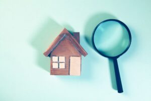 A landlord and tenant review a rental checklist in a clean, unfurnished living room.