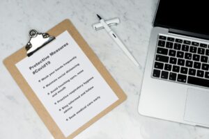 Tenant and landlord reviewing a lease beside keys, a move-in checklist, and a rental home inspection folder.